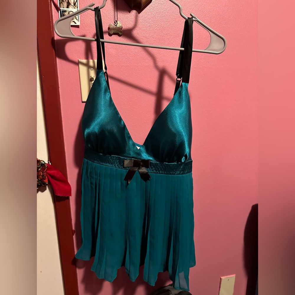 Teal satin baby doll top with black bow and accordion pleats, the top is padded